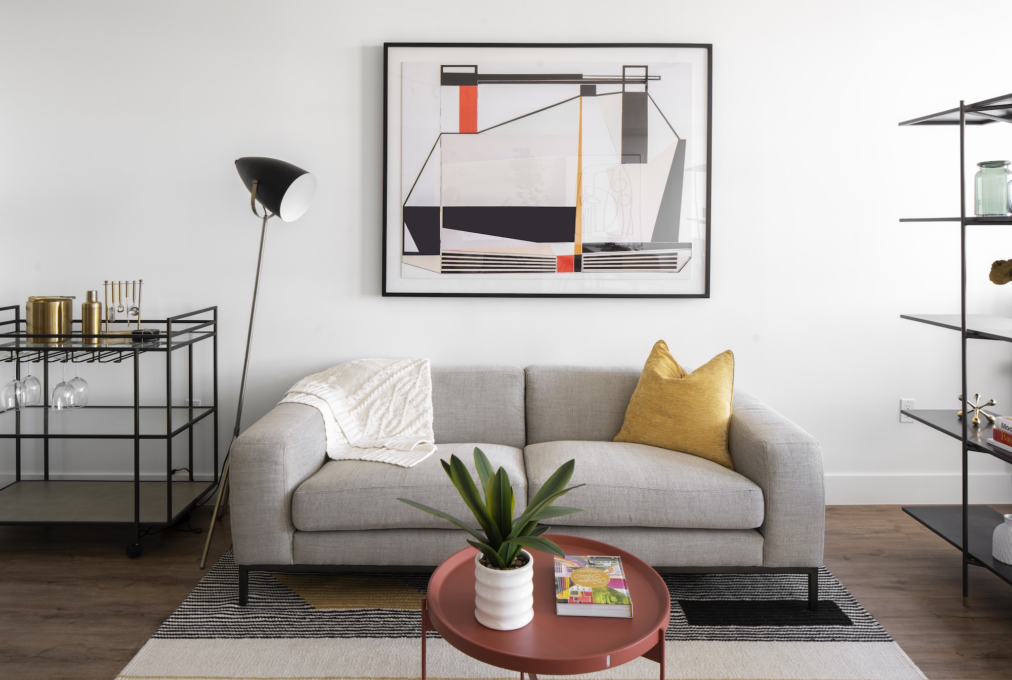 a couch next to a lamp and coffee table