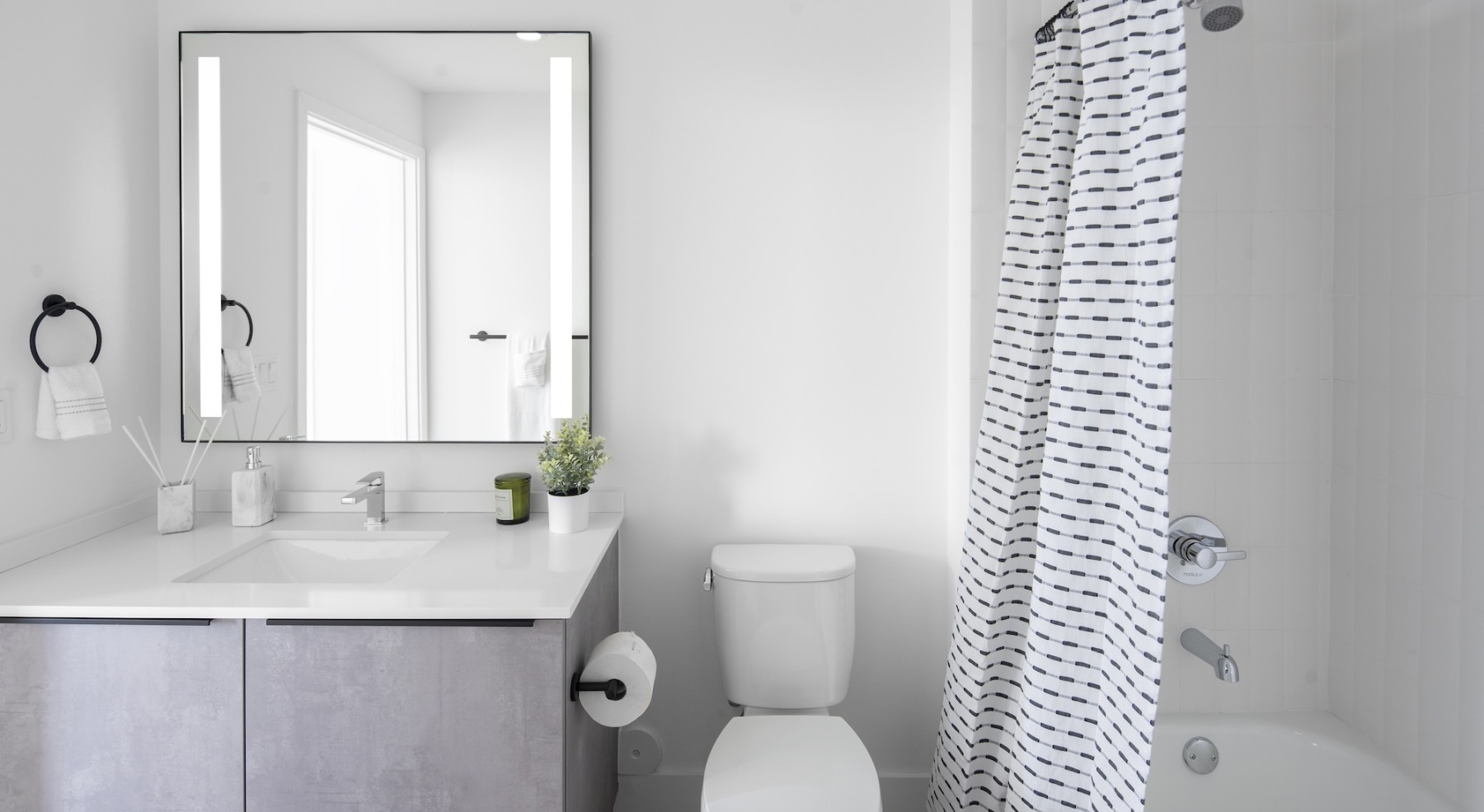 bathroom with sink mirror toilet and shower