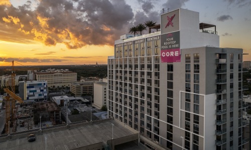 Love where you live large building with several floors and view of a downtown area