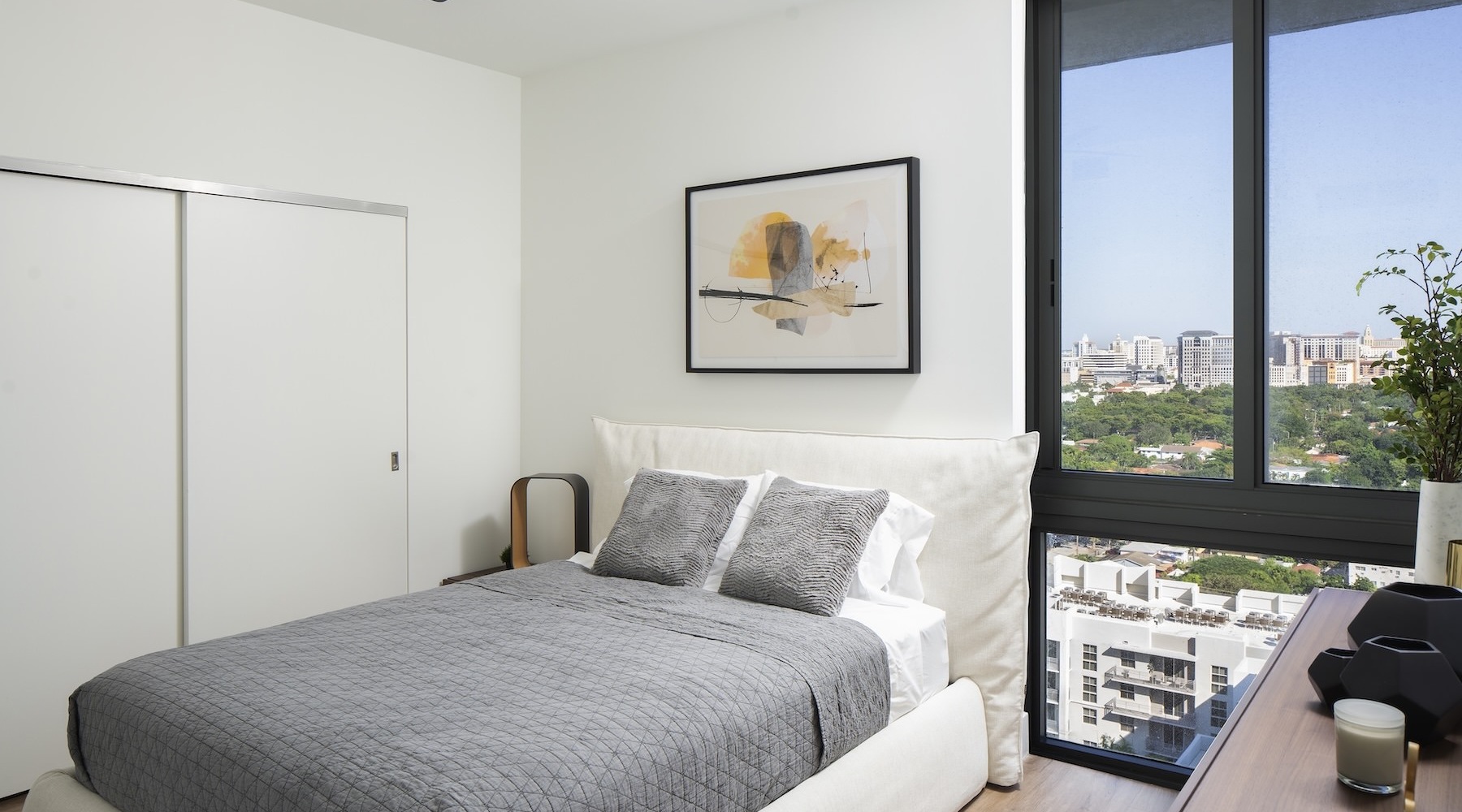 a bedroom with a bed and a large window