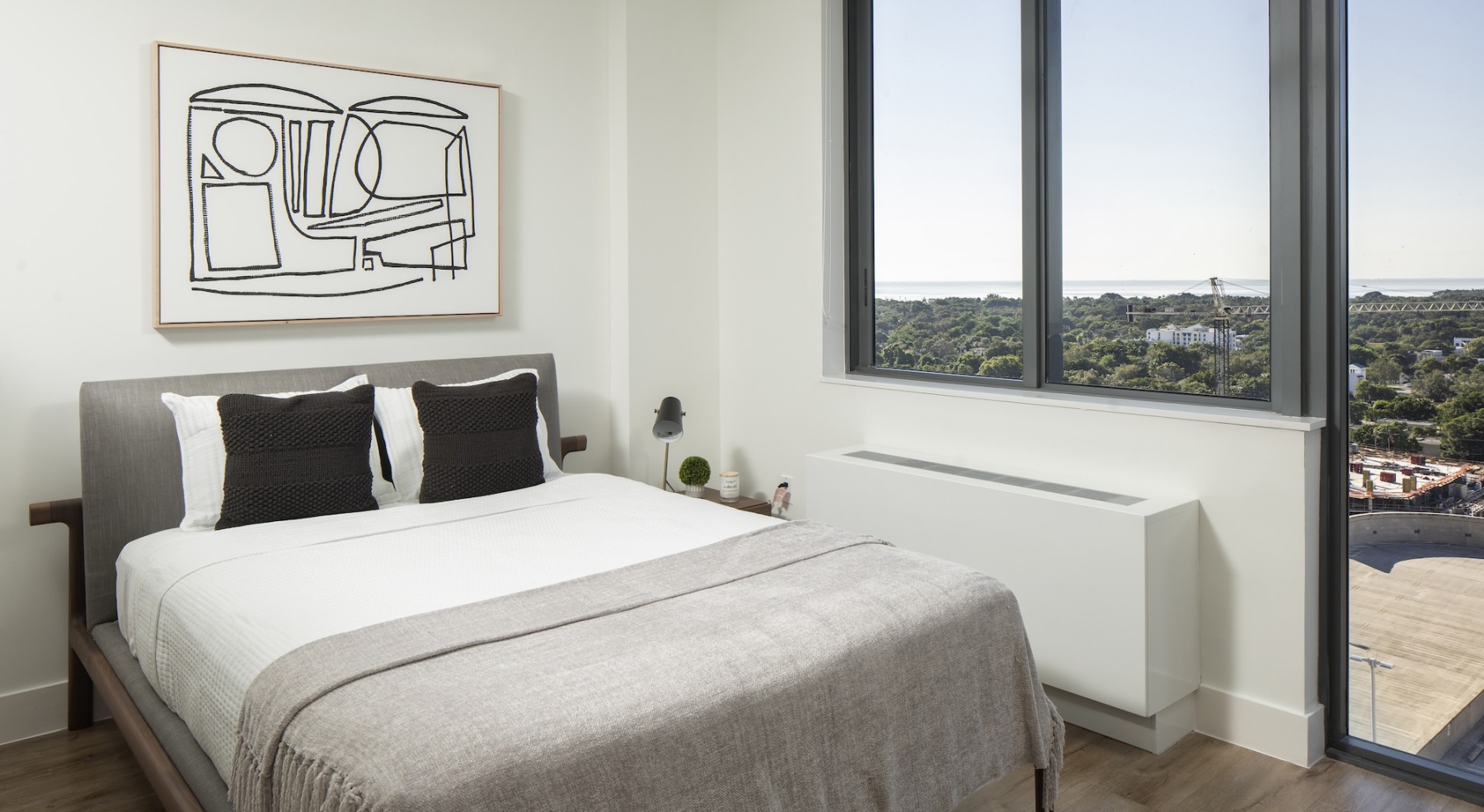 bed next to large windows