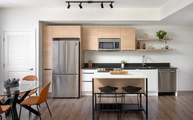 a kitchen with an island and a dining table and chairs