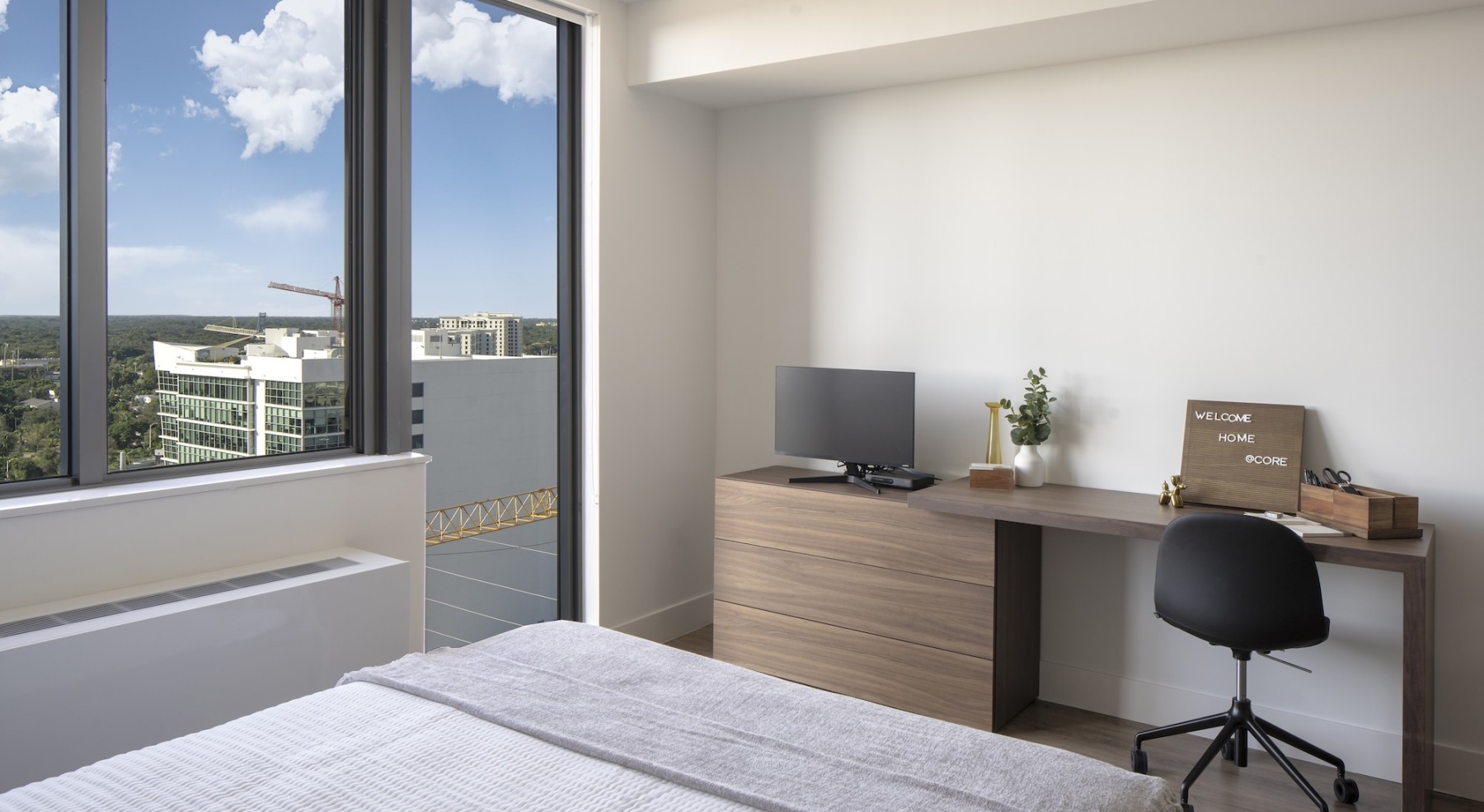 bedroom with desk computer chair and table