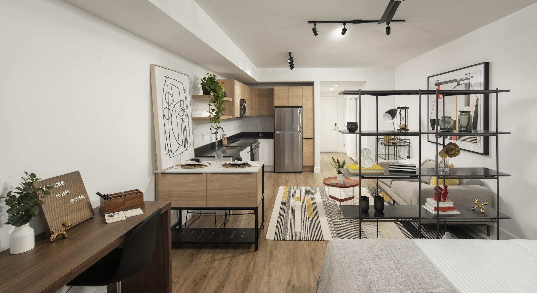 a bedroom with view of a kitchen 