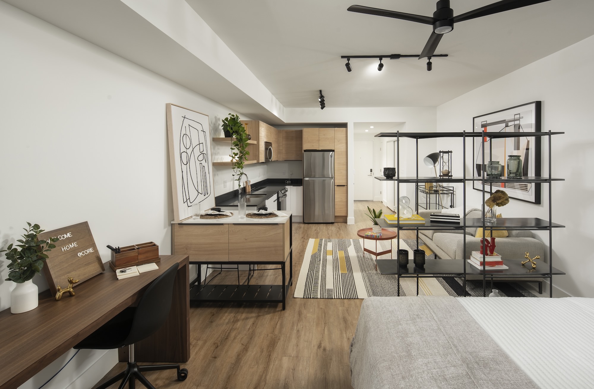 a bedroom with view of a kitchen 